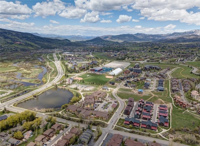 birds eye view of property with a water and mountain view