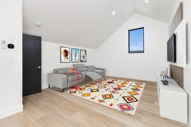 living room with vaulted ceiling and light hardwood / wood-style flooring