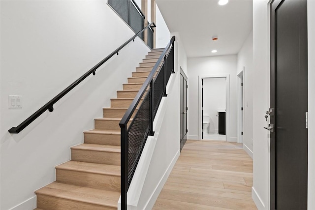 stairs with hardwood / wood-style floors