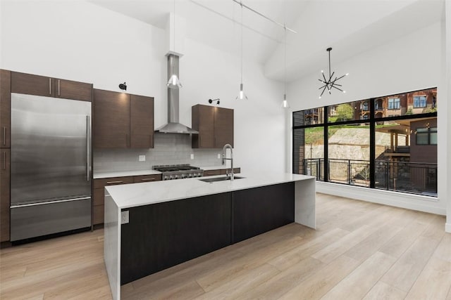 kitchen featuring tasteful backsplash, sink, appliances with stainless steel finishes, and a high ceiling