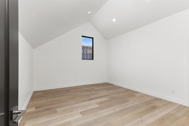 unfurnished living room with a tile fireplace, light hardwood / wood-style flooring, high vaulted ceiling, and french doors