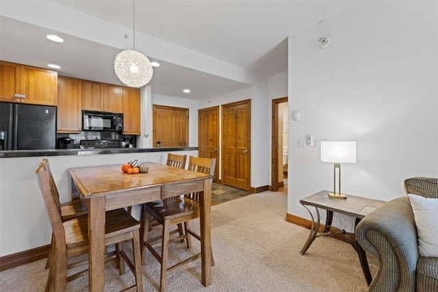 dining area featuring baseboards, recessed lighting, and light colored carpet
