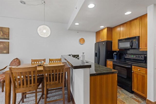 34 Highfield Trl Unit 203, Breckenridge, CO 80424 - kitchen with recessed lighting, brown cabinets, decorative light fixtures, tile countertops, and black appliances