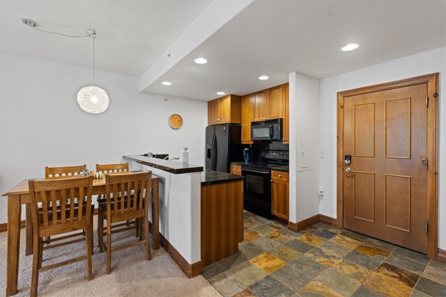 34 Highfield Trl Unit 203, Breckenridge, CO 80424 - kitchen with black appliances, a peninsula, baseboards, stone finish floor, and recessed lighting