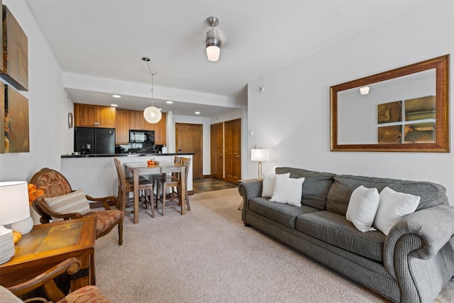 living area with recessed lighting and light colored carpet
