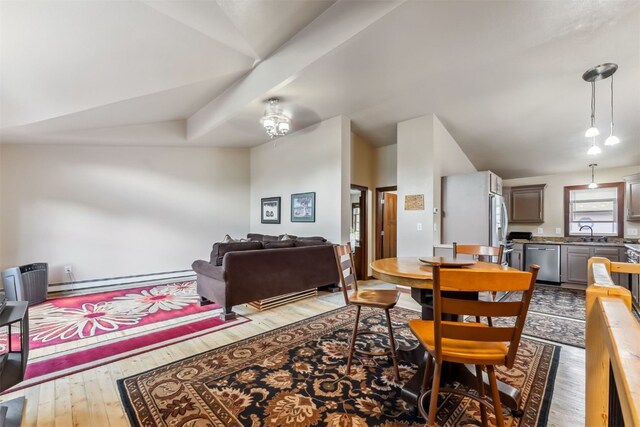 245 Tennis Ct, Silverthorne, CO 80498 - dining area with a baseboard radiator, hardwood / wood-style floors, and vaulted ceiling