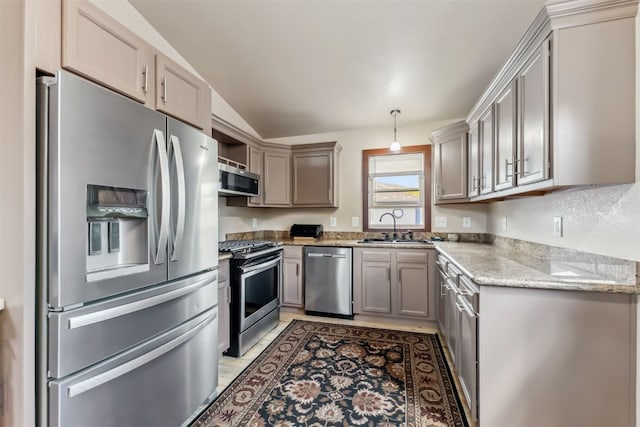 245 Tennis Ct, Silverthorne, CO 80498 - kitchen featuring stainless steel appliances, a sink, lofted ceiling, light stone countertops, and gray cabinetry