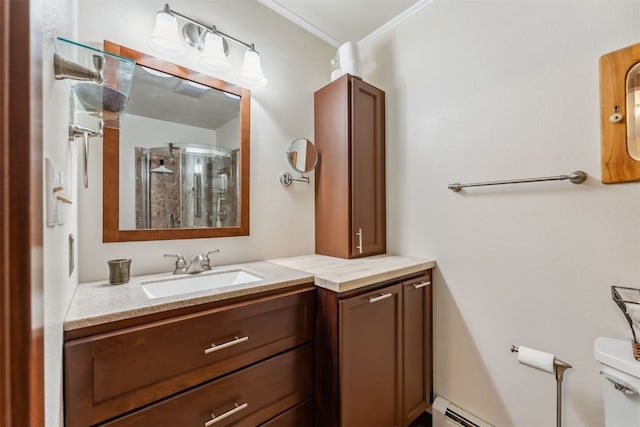 245 Tennis Ct, Silverthorne, CO 80498 - bathroom featuring vanity, crown molding, a baseboard radiator, an enclosed shower, and toilet