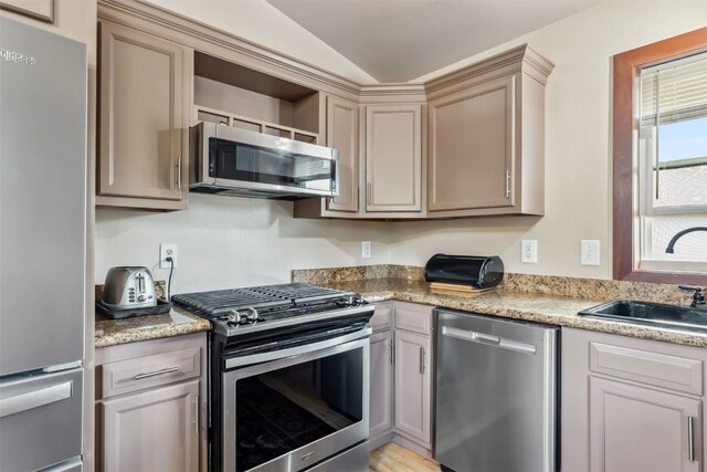 245 Tennis Ct, Silverthorne, CO 80498 - kitchen with appliances with stainless steel finishes, a sink, lofted ceiling, and light countertops