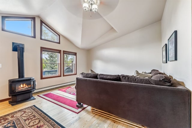 245 Tennis Ct, Silverthorne, CO 80498 - living room featuring a baseboard radiator, wood-type flooring, ceiling fan, lofted ceiling, and a wood stove
