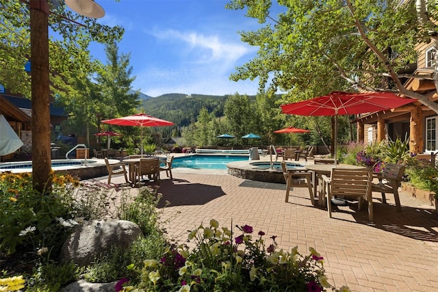 150 Dercum Sq Unit 8499, Keystone, CO 80435 - swimming pool featuring an in-ground hot tub, a patio area, a mountain view, and outdoor dining space