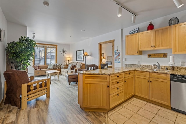 150 Dercum Sq Unit 8499, Keystone, CO 80435 - kitchen with a sink, stainless steel dishwasher, open floor plan, a peninsula, and light stone counters