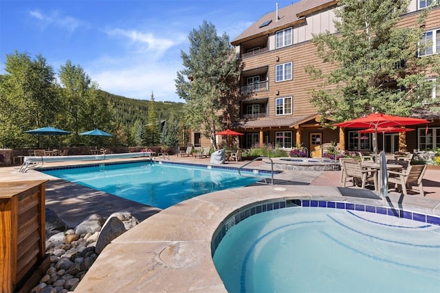 150 Dercum Sq Unit 8499, Keystone, CO 80435 - view of swimming pool featuring a community hot tub, a patio area, and a covered pool