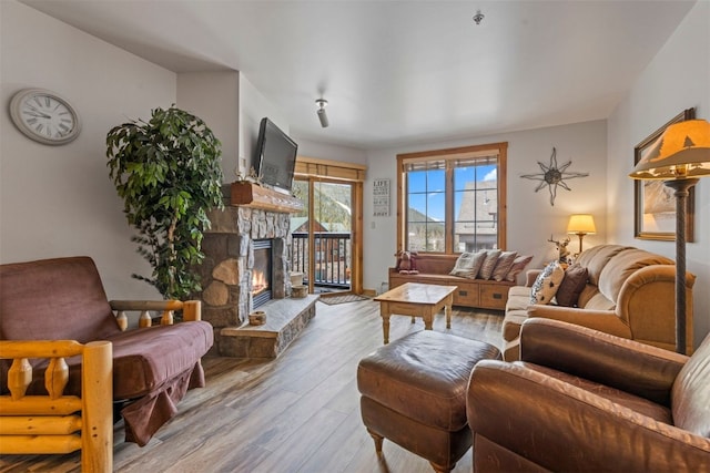 150 Dercum Sq Unit 8499, Keystone, CO 80435 - living room featuring a stone fireplace and wood finished floors
