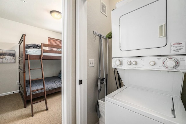 laundry area with stacked washer and dryer, light carpet, visible vents, and laundry area