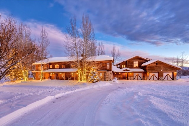 32505 County Road 20, Steamboat Springs, CO 80487 - view of front of home featuring stone siding and a garage