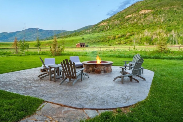 32505 County Road 20, Steamboat Springs, CO 80487 - view of patio / terrace featuring an outdoor fire pit, a mountain view, and a view of countryside