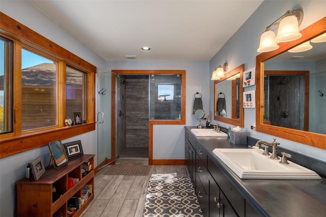32505 County Road 20, Steamboat Springs, CO 80487 - full bathroom featuring a stall shower, wood finished floors, double vanity, recessed lighting, and baseboards