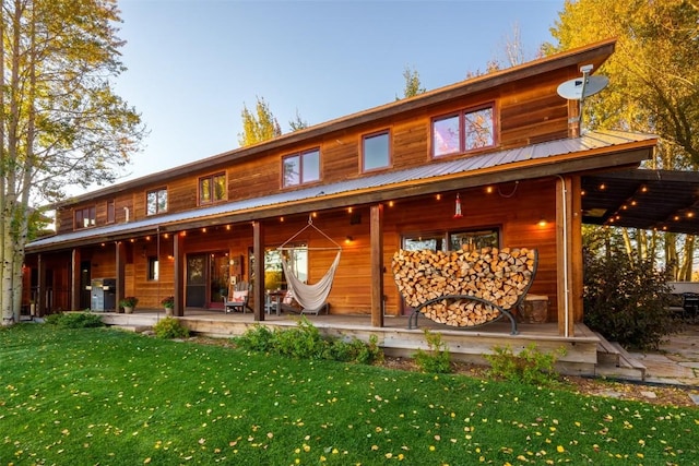 32505 County Road 20, Steamboat Springs, CO 80487 - back of property with a yard, a porch, and metal roof