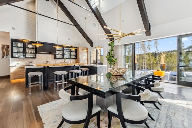 257 Barton Ridge Dr, Breckenridge, CO 80424 - dining room featuring high vaulted ceiling, beamed ceiling, dark wood-style flooring, and healthy amount of natural light