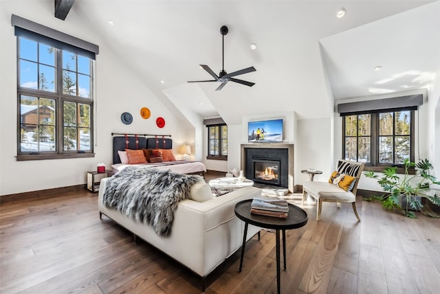 257 Barton Ridge Dr, Breckenridge, CO 80424 - bedroom featuring a glass covered fireplace, hardwood / wood-style floors, recessed lighting, high vaulted ceiling, and a ceiling fan