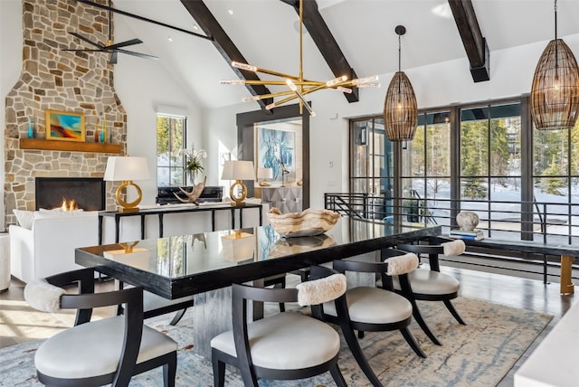 257 Barton Ridge Dr, Breckenridge, CO 80424 - dining space with beamed ceiling, high vaulted ceiling, a stone fireplace, a chandelier, and wood finished floors