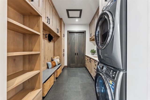 257 Barton Ridge Dr, Breckenridge, CO 80424 - laundry area with stacked washer / drying machine, cabinet space, and dark tile patterned flooring