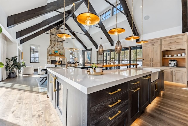 257 Barton Ridge Dr, Breckenridge, CO 80424 - kitchen featuring a spacious island, high vaulted ceiling, light countertops, beam ceiling, and wood finished floors