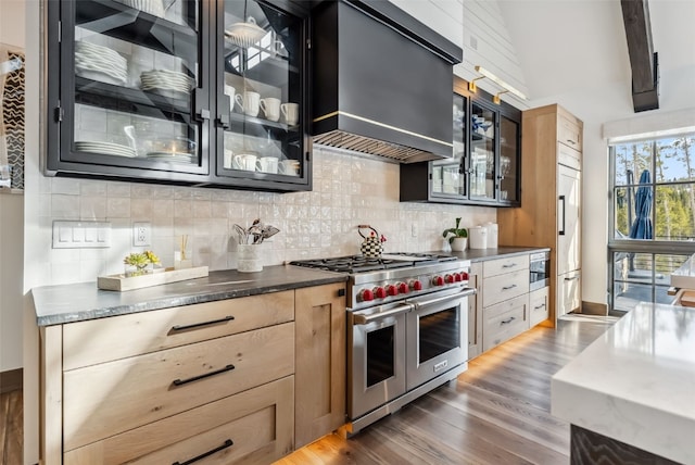 257 Barton Ridge Dr, Breckenridge, CO 80424 - kitchen featuring range with two ovens, tasteful backsplash, dark wood finished floors, glass insert cabinets, and dark cabinetry