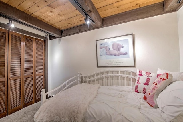 51 Salt Lick Cir Unit 51, Silverthorne, CO 80498 - carpeted bedroom featuring a wood ceiling with exposed beams, rail lighting, a closet, and a barn door