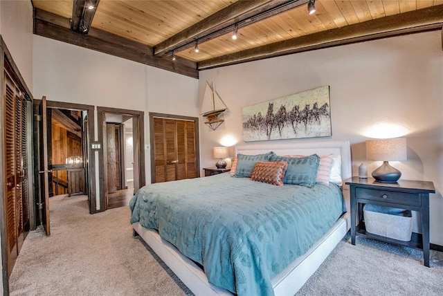 51 Salt Lick Cir Unit 51, Silverthorne, CO 80498 - bedroom featuring track lighting, a wooden ceiling with exposed beams, carpet floors, and a high ceiling