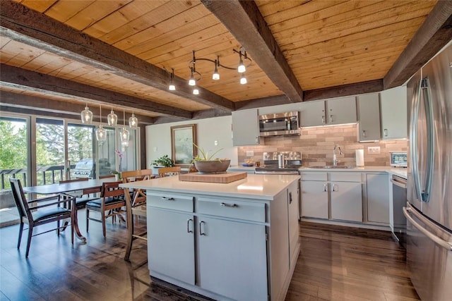 51 Salt Lick Cir Unit 51, Silverthorne, CO 80498 - kitchen featuring appliances with stainless steel finishes, a wood ceiling with exposed beams, dark wood finished floors, light countertops, and a center island