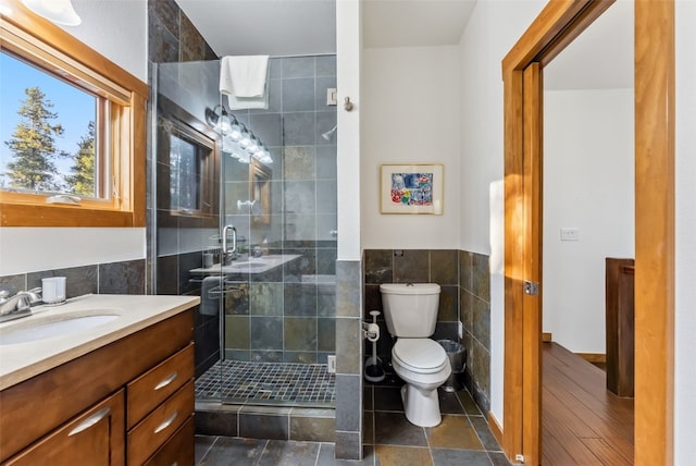 564 White Cloud Dr, Breckenridge, CO 80424 - bathroom with tile walls, vanity, a shower stall, and a wainscoted wall