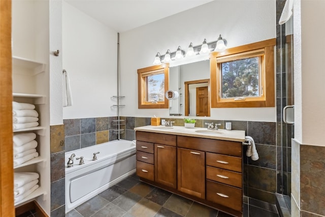 564 White Cloud Dr, Breckenridge, CO 80424 - bathroom with tile walls, double vanity, a garden tub, a tile shower, and a wainscoted wall