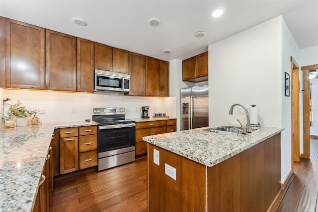564 White Cloud Dr, Breckenridge, CO 80424 - kitchen with stainless steel appliances, dark wood-type flooring, brown cabinetry, and light stone counters