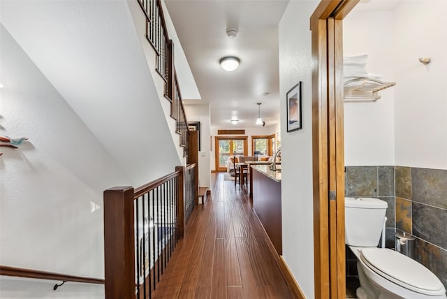 564 White Cloud Dr, Breckenridge, CO 80424 - corridor featuring tile walls, dark wood-style flooring, and a wainscoted wall