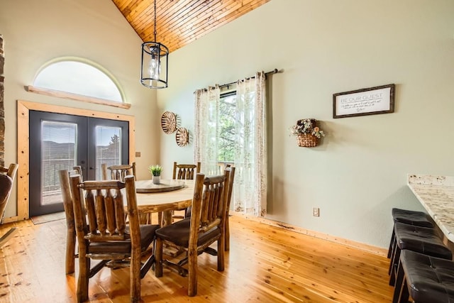 133 Lake Dr, Florissant, CO 80816 - dining room featuring high vaulted ceiling, wood ceiling, french doors, light wood finished floors, and baseboards