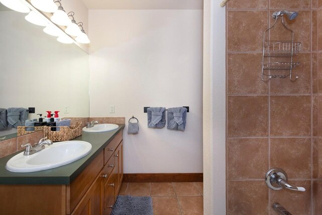 bathroom featuring tile patterned floors, vanity, and walk in shower