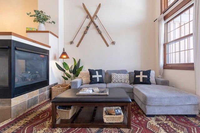 living room featuring a tiled fireplace