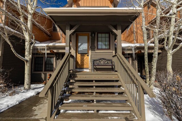 view of snow covered property entrance