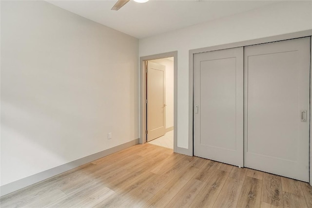 75 W 4th St Unit 204W, Silverthorne, CO 80498 - unfurnished bedroom featuring light wood-type flooring, a ceiling fan, baseboards, and a closet