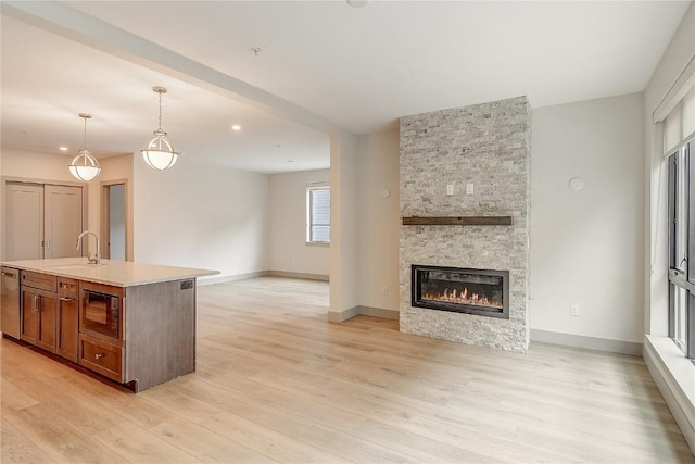 75 W 4th St Unit 204W, Silverthorne, CO 80498 - kitchen with built in microwave, light wood-style floors, dishwasher, and open floor plan