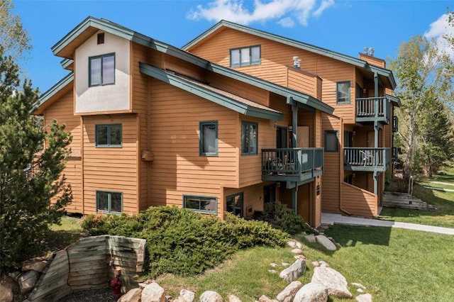 480 Ore House Plz Unit 106, Steamboat Springs, CO 80487 - rear view of property featuring a chimney and a yard