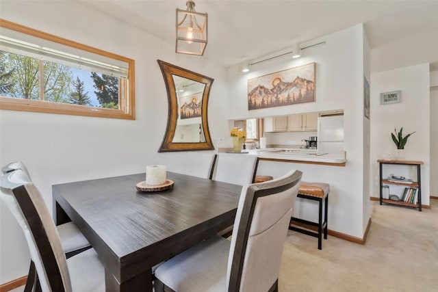 480 Ore House Plz Unit 106, Steamboat Springs, CO 80487 - dining area with track lighting, light carpet, and baseboards
