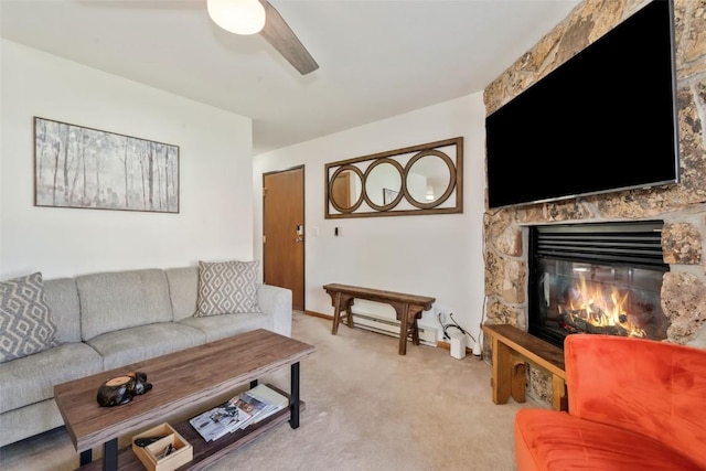 480 Ore House Plz Unit 106, Steamboat Springs, CO 80487 - living area featuring ceiling fan, light carpet, a baseboard radiator, and a fireplace