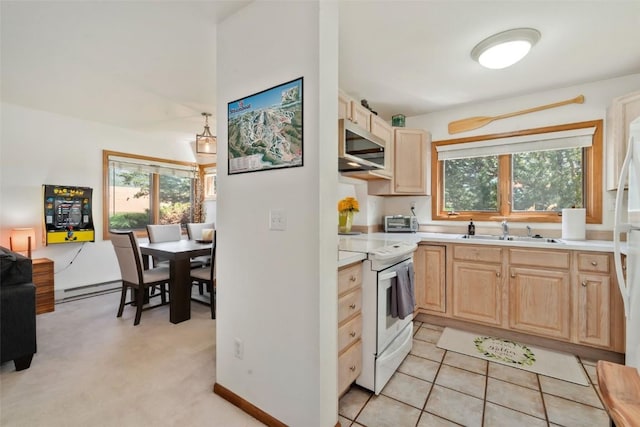480 Ore House Plz Unit 106, Steamboat Springs, CO 80487 - kitchen featuring white appliances, light brown cabinetry, a sink, baseboard heating, and healthy amount of natural light