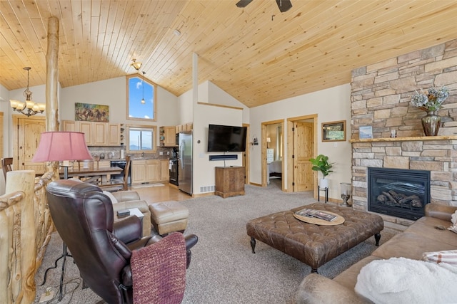1729 Pinto Trl, Como, CO 80432 - living room with high vaulted ceiling, wood ceiling, a chandelier, a stone fireplace, and light colored carpet