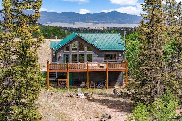 1729 Pinto Trl, Como, CO 80432 - back of property with a deck with mountain view and a metal roof