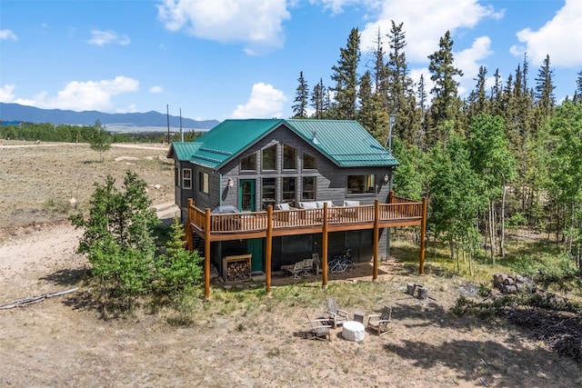 1729 Pinto Trl, Como, CO 80432 - back of property featuring a deck with mountain view and a metal roof