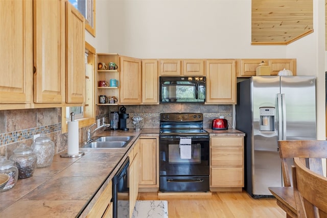 1729 Pinto Trl, Como, CO 80432 - kitchen with black appliances, light brown cabinets, high vaulted ceiling, backsplash, and light wood-type flooring